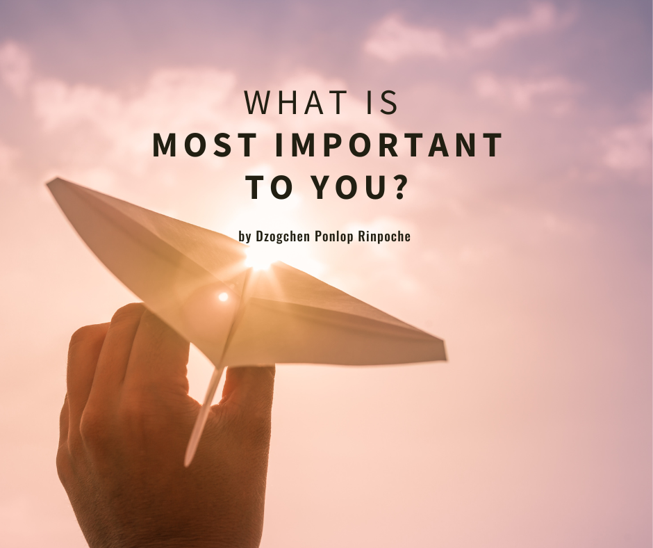 Hand at bottom of image holds a paper airplane, in line with sunburst in a peaceful, mauve pink sky